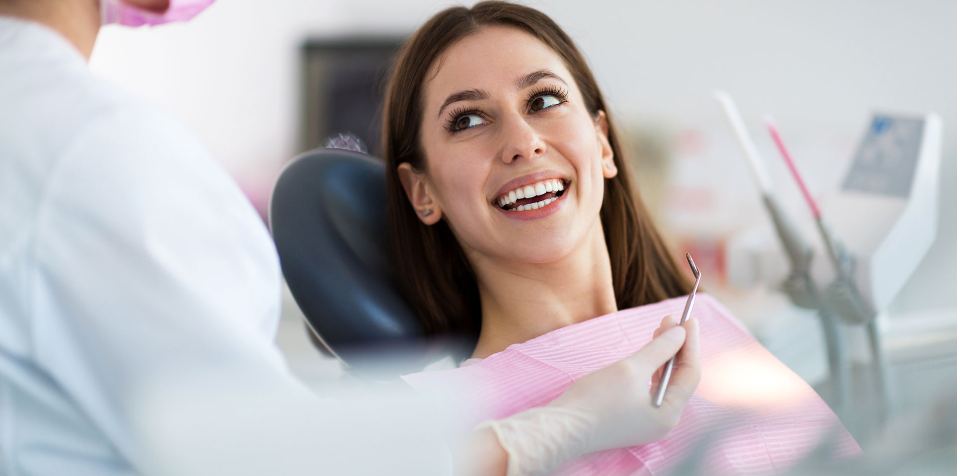 Smiling woman sitting on dental chair