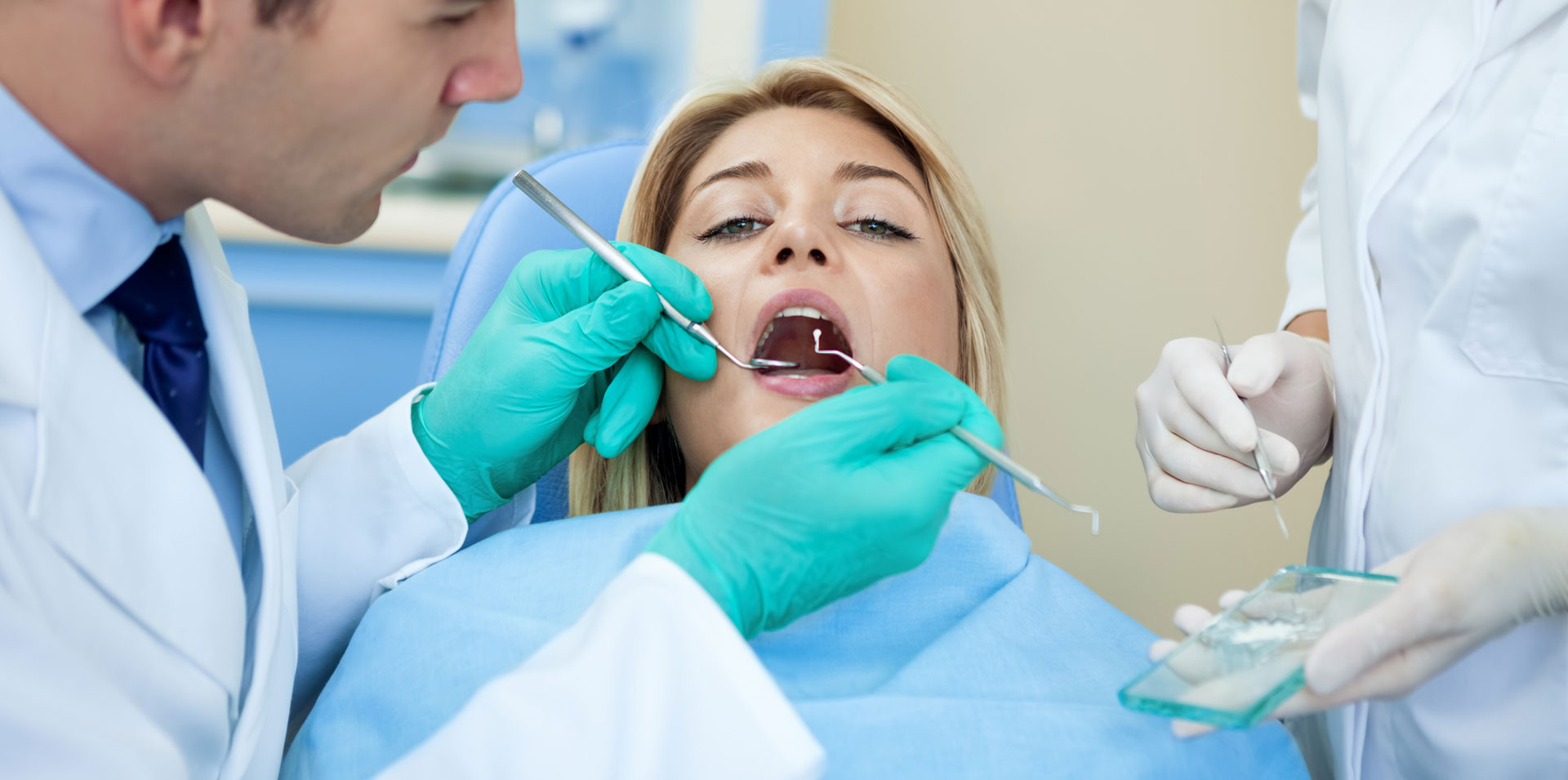 A dentist examining patient teeth